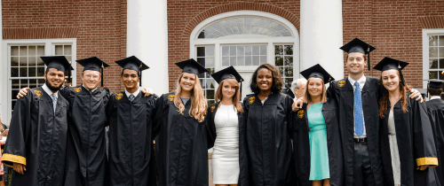 Centre graduates standing in front of Old Centre